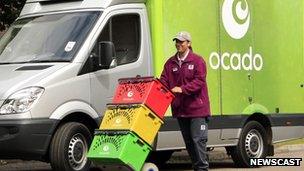 Delivery driver in front of Ocado van