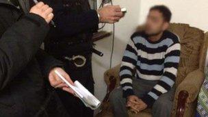 Officers question a man in connection with the crackdown