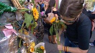 People lay flowers in memory of Hope Fennell