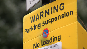 Suspended parking sign