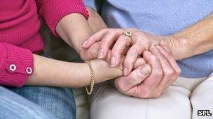 Carer comforting woman