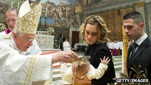 Pope Benedict XVI performs a baptism in the Sistine Chapel (13 January 2013)