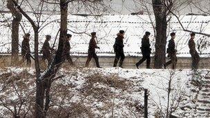 North Korean soldiers patrol along the Yalu River at the North Korean town of Sinuiju on February 12, 2013 across from the Chinese city of Dandong.