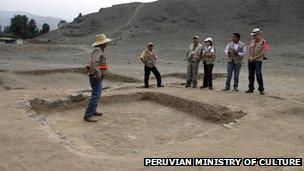 Archaeologists examine the remains of a hearth at the centre of a temple structure