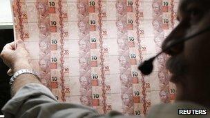 Brazilian Mint worker checks sheet of 10-real banknotes