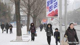 North Koreans walk on a street in Pyongyang, 12 February 2013, in this photo taken by Kyodo