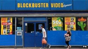 People walk past Blockbusters store (file photo 2010)