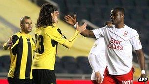 Beitar Jerusalem players (in yellow) and Bnei Sakhnin players congratulate each other after a match at the Teddy Kollek Stadium in Jerusalem on 10 February 2013