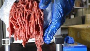 Beef being put through a mincer