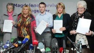 Members of the Magdalene Survivors Together campaign group hold copies of the report