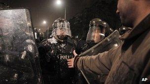 Bulgarian protester against high electricity prices confronts riot police in Sofia