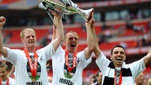 Alan Tate, Garry Monk and Leon Britton lift the Championship play-off trophy.