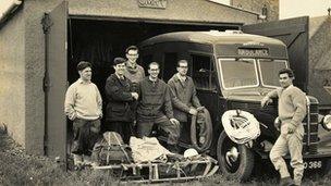 Team members with an ambulance in the 1950s