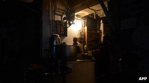 A Pakistani man preparing tea at his restaurant during a nationwide power blackout in Karachi, 24 February 2013