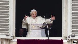 Pope Benedict XVI delivers his blessing during his last Angelus noon prayer, from the window of his studio overlooking St Peter's Square, at the Vatican (24 Feb 2013)