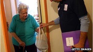 Woman receives a meal from a volunteer