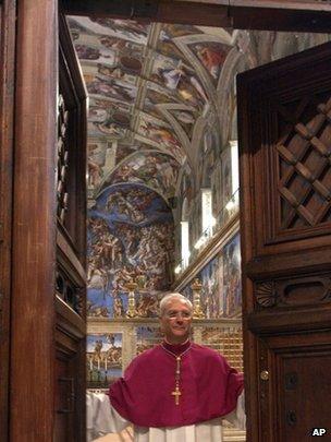 Master of Liturgical Celebrations Archbishop Piero Marini closes the door of the Sistine Chapel after proclaiming "Extra omnes" at the beginning of the conclave, 18 April 2005