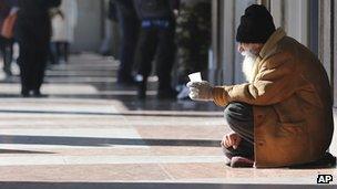 A man begs in Milan. Photo: February 2013