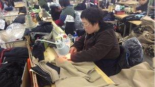 Woman sewing in a factory