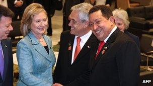 Hillary Clinton shakes hands with Hugo Chavez