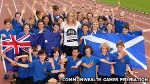 Hurdler Sally Pearson celebrates with school children in Sydney, Australia