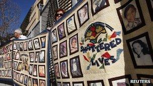 People hold quilts at a press conference outside of Cathedral of Our Lady of the Angels for victims of sexual abuse by priests in the Catholic Archdiocese of Los Angeles