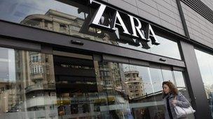 Woman walks past Zara store