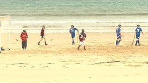 Shinty played on beach