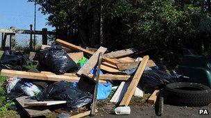 Rubbish dumped by a sign that reads "No Dumping"