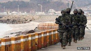 South Korean marines patrol on Yeonpyeong Island near the western maritime border between the two Koreas, 12 March 2013