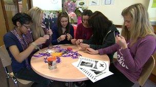 Pupils making purple ribbons at Leasowes School