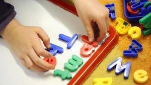 Child putting letters on board