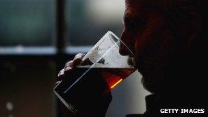 Close up of man drinking pint of beer