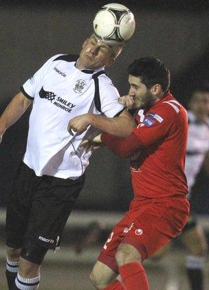 Distillery's Aaron Boyd gets above Portadown midfielder Sean Mackle