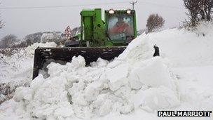 A tractor clears a road on the Isle of Man