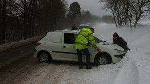 A car caught in snow on the A75