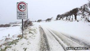 A road sign covered in snow in the Isle of Man