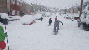 People clearing snow in Mynydd Isa