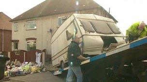 Caravan being taken from house for forensic examinations