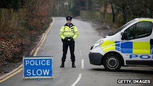 Police guard the road to the Berezovksy property