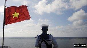 A Vietnamese naval soldier stands quard at Thuyen Chai island in the Spratly archipelago on 17 January 2013