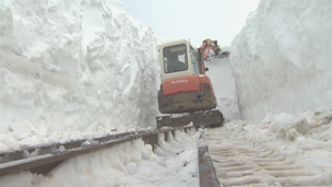 Digger clearing track of snow on Snowdon Mountain Railway in March, 2013