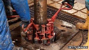 Engineers work on drilling platform at fracking facility