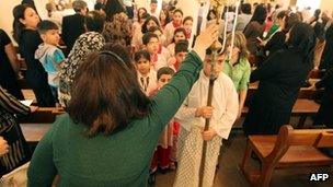 Christians attend church in Baghdad, Iraq, 31 March