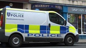Police van outside covered market