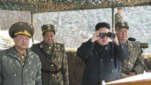 North Korean leader Kim Jong-un (C) watches what the country's media said was a drill of drone planes at an undisclosed location