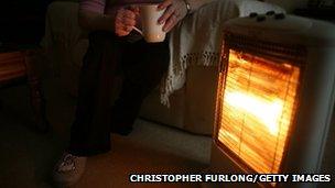 Woman sat next to heater