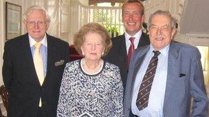 Thatcher at surrounded by three men at Chatham Dockyards