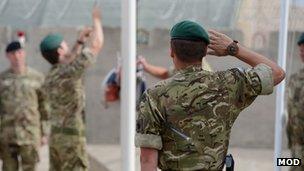 Marines lower the flag at their base in Afghanistan for the final time