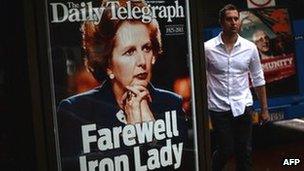 A man walks by a display of the Sydney tabloid newspaper the Daily Telegraph marking the death of former British Prime Minister Margaret Thatcher in Sydney on Tuesday